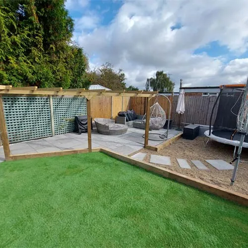 a backyard with grass and a wooden fence
