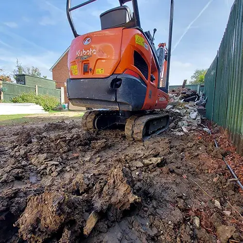 A small machine is digging through the dirt.