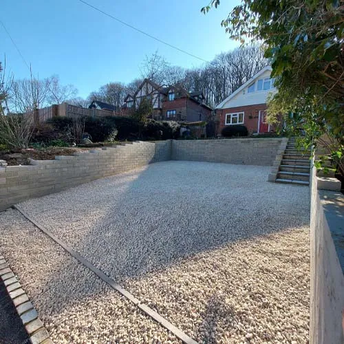 a concrete block retaining wall with steps leading up to it
