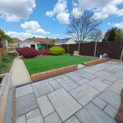 a backyard with a lawn and a fence