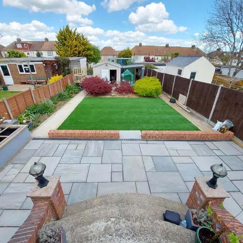 a backyard with a lawn and a fence