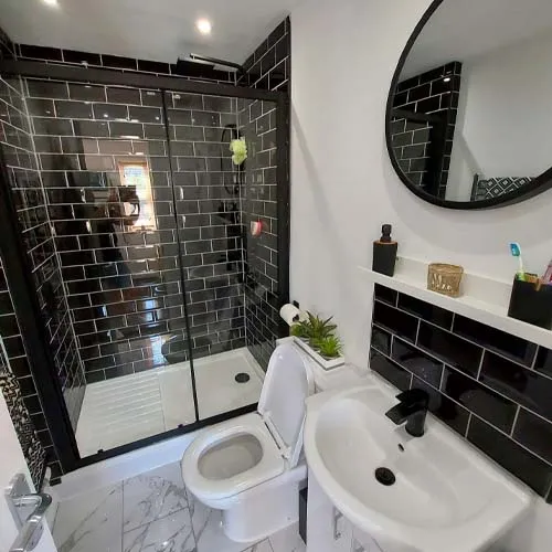 a white toilet sitting next to a white sink