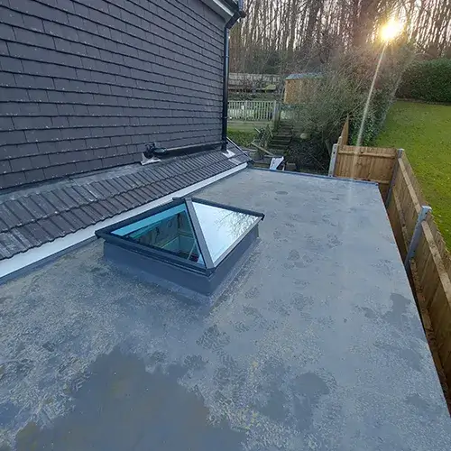 A flat roof with a skylight on top of it.