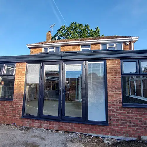 A brick building with glass doors and windows.