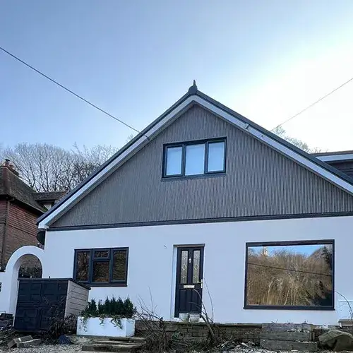 A white house with a black door and windows.