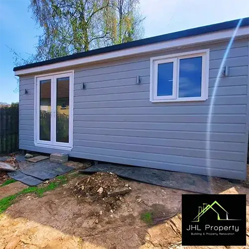 view of grey shed at end of garden