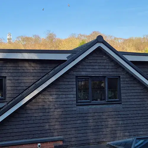 side view of 3 window on top floor