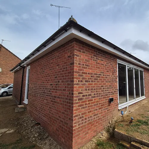 A red brick building with a white roof.