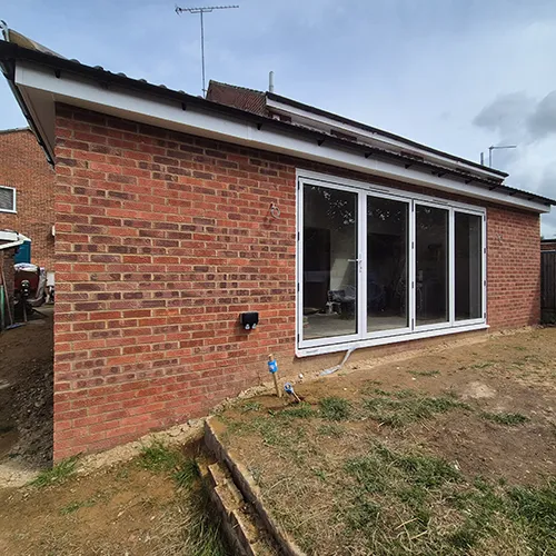 A brick house with a large sliding glass door.